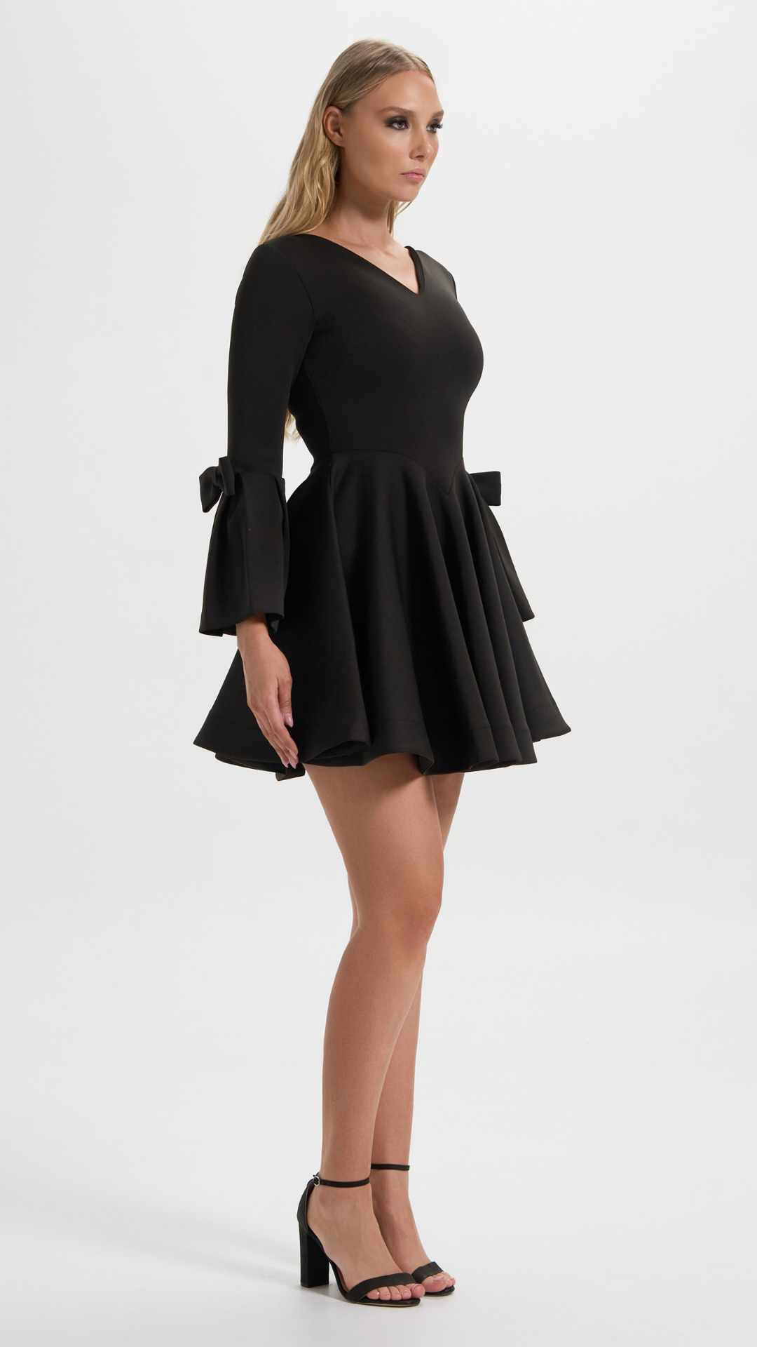 Boardroom to Cocktail Hour Dress in Black with the signature ribbon sleeve perfect for your cocktail events (Side Details)